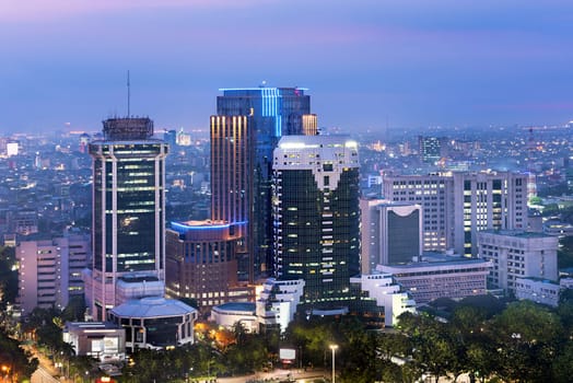Jakarta city skyline with urban skyscrapers at night. Jakarta, Indonesia