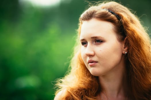 portrait of a girl against a nature background.