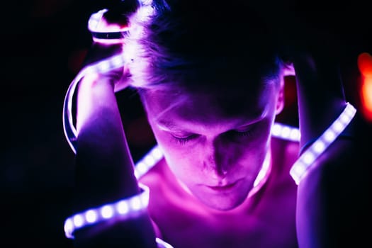 Portrait man Strip Light LED tape on dark color background.