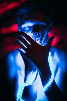 Portrait man Strip Light LED tape on dark color background.