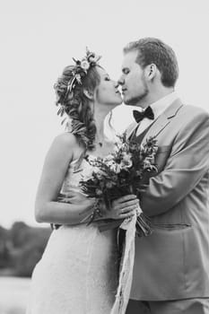 black white photo young couple in the style of provence on background of river.