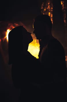 silhouette couple in fashionable clothes on a shiny background.