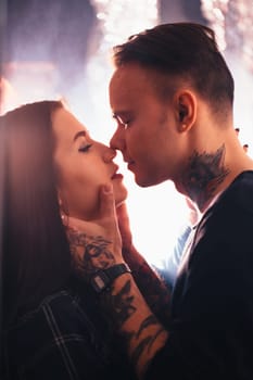 guy and the girl kiss closeup on a light background