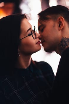 guy and the girl kiss closeup on a light background