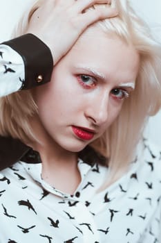 portrait blonde albino girl in studio on white background.
