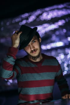 portrait of a guy in a hat on a blurred background.