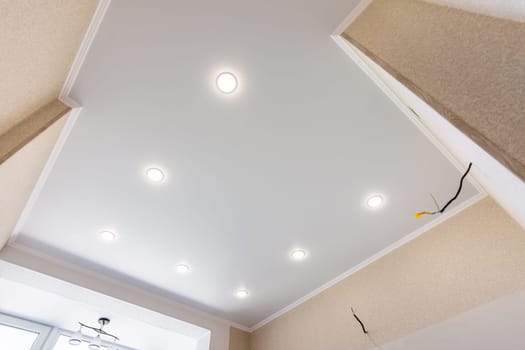 Stretch ceiling in the kitchen with installed and included spotlights