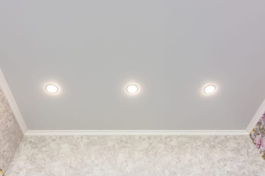 Three spotlights built into the suspended ceiling