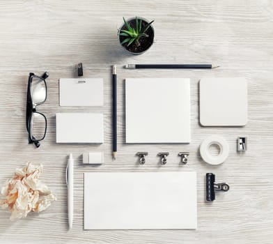 Blank stationery set. Corporate identity template on light wooden background. Flat lay.