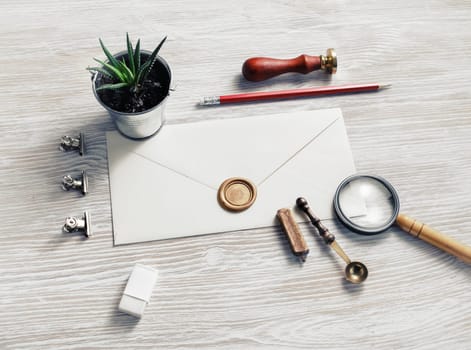Blank envelope and retro stationery light wood table background. Responsive design mockup.