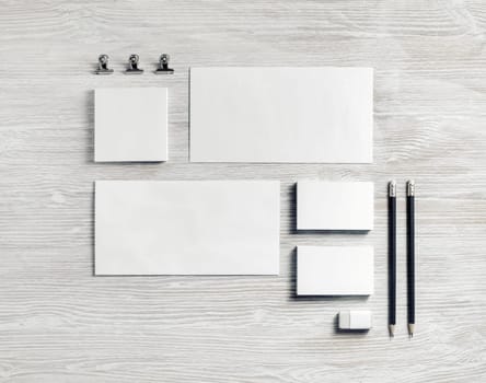 Blank corporate identity template on light wooden background. Photo of blank stationery. Mockup for design presentations and portfolios. Flat lay.
