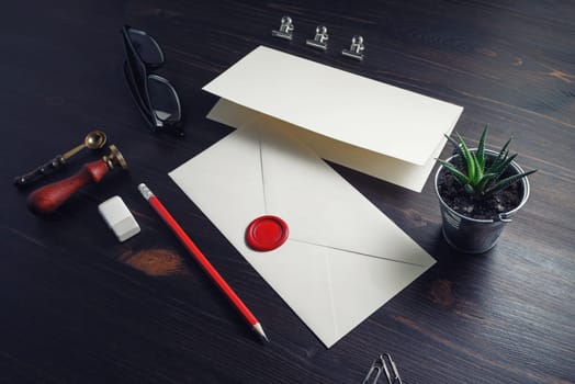 Vintage envelope and stationery on wooden background. Responsive design mockup.