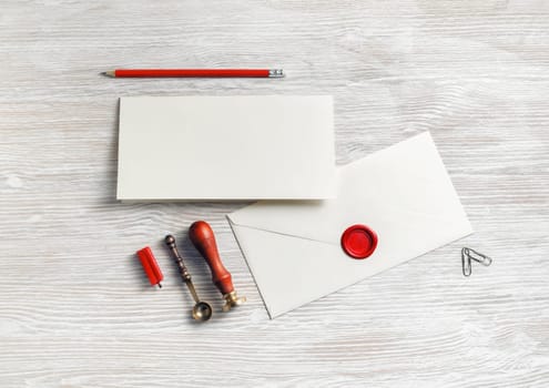 Vintage stationery set on light wood table background. Responsive design mockup. Flat lay.