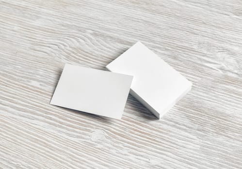 Mockup of blank business cards on light wooden background. Branding mock up.