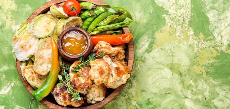 Grilled peas,cauliflower and zucchini.Grill vegetables.Summer food.Baked vegetables.Vegetarian food