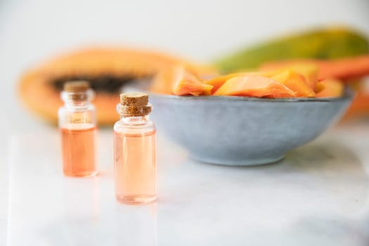 Small bottles of papaya extract with papaya fruit
