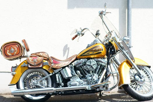 Mainz, Germany - May 24, 2019: The side view of a gold-painted Harley Davidson Screamin Eagle motorcycle on May 24, 2019 in Mainz....