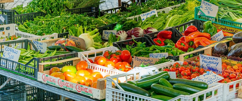 Rome, Italy, February 2017: mixed vegetables, including tomatoes, peppers and courgettes, on sale in a stand in the historic Campo de Fiori street market in Rome
