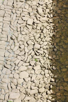 Stones at a shore embankment, background image