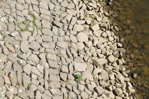 Stones at a shore embankment, background image