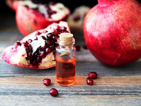 Fresh pomegranate pieces and a small bottle of pomegranate extract.