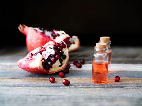 Fresh pomegranate pieces and a small bottle of pomegranate extract.