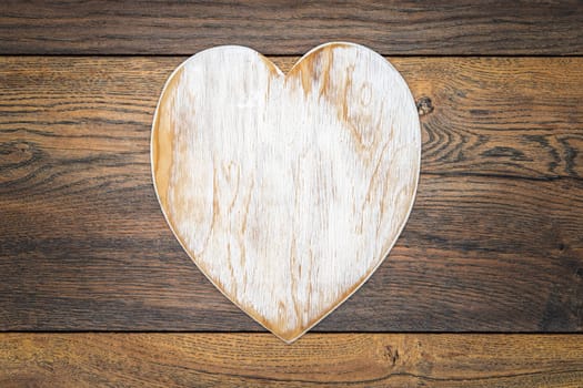 Retro classic Valentines Day cad, large white painted wooden hart isolated and in centre on vintage oak panels, top view