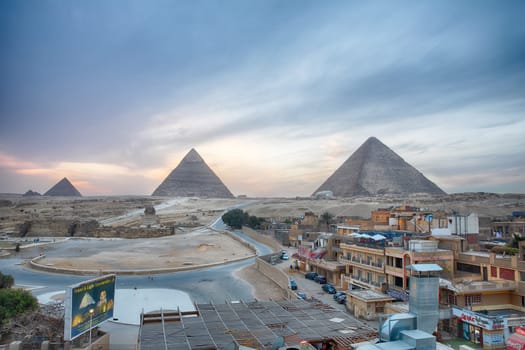 Giza, Cairo. Egypt - March 24, 2019: View on the town and the Great Pyramids in the evening