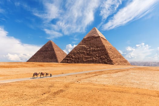 The Giza Pyramids in the desert, sunny day scenery.