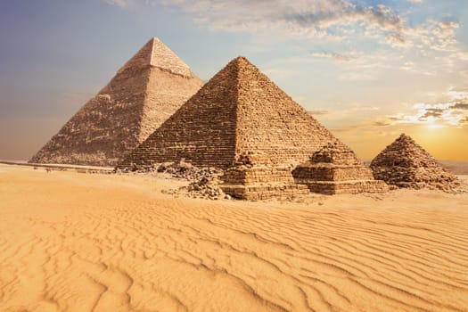 Beautiful sunset view of the Pyramid of Menkaure with companions and the Pyramid of Chephren, Egypt.