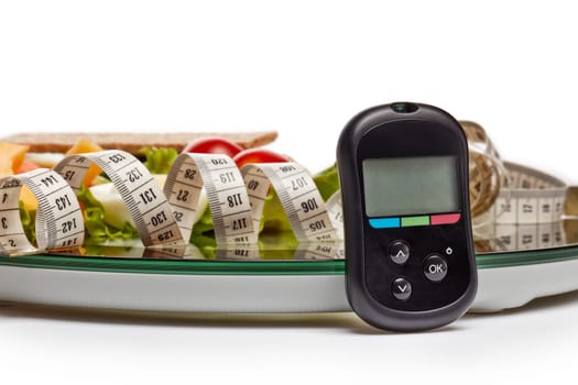 Still life with healthy food, scales, measuring tape and blood glucose meter on white background. Concept: control of level glucose. Healthy lifestyle, healthy food, slimming