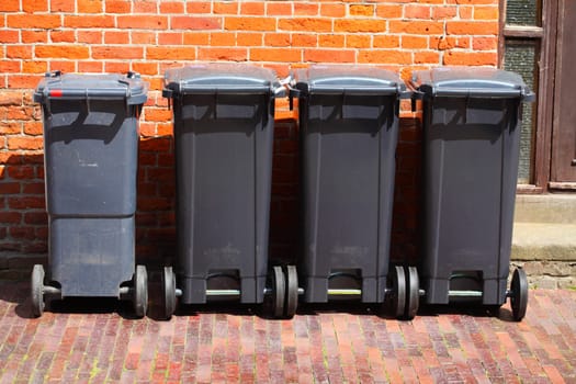 Recycling bins, rubbish bins for residual waste standing on the sidewalk, Germany, Europe