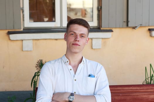 Young man sitting on bench in outdoors