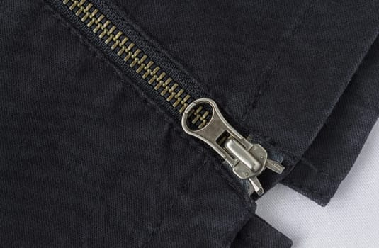 End of Closed Brass Zip on Black Jeans Texture Background. Closed Brass Zip on Black Jeans Texture Background for Apparel Design