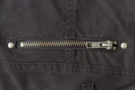 Closed Brass Zip on Black Jeans Texture Background. Closed Brass Zip on Black Jeans Texture Background for Apparel Design