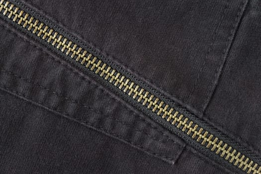 Brass Zip on Black Jeans Texture Background. Closed Brass Zip on Black Jeans Texture Background for Apparel Design