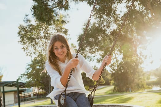 Teenage girl using a swing.