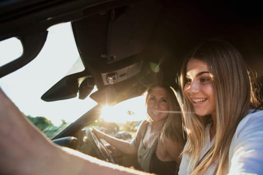Mother and daughter inside their car going for a drive.
