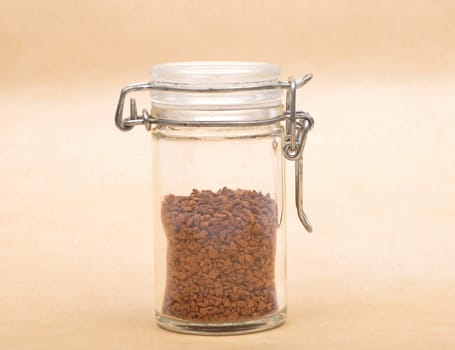 Instant Coffee in closed jar on brown background
