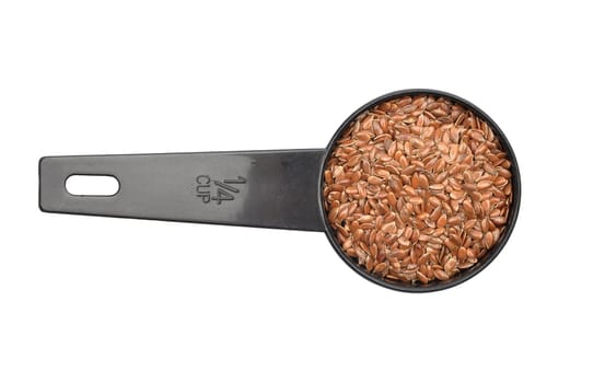 Linseed in measuring spoon on white background