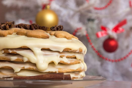 Homemade cake with condensed milk, on the background of the Christmas tree