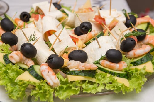 Konope snack on skewers, salad, cheese, shrimp and olive