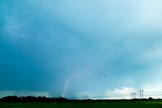 Lightning over Agricultural Field with a cloudy sky.