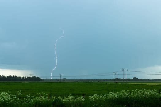 Lightning over Agricultural Field with a cloudy sky.