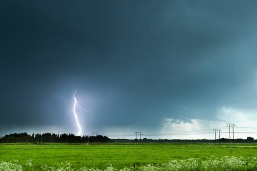 Lightning over Agricultural Field with a cloudy sky.