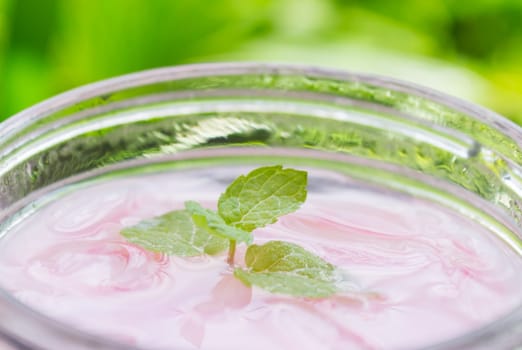 Pink Cold Milk Beverage or Cold Drinks and Tree Background Close-Up View. Pink cold drinks and ice on wood table for drink