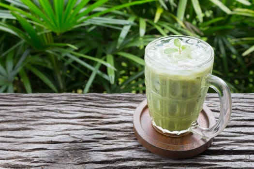 Cold Green Tea Milk Beverage or Cold Drinks Right Frame. Green cold drinks and ice on wood table for drink