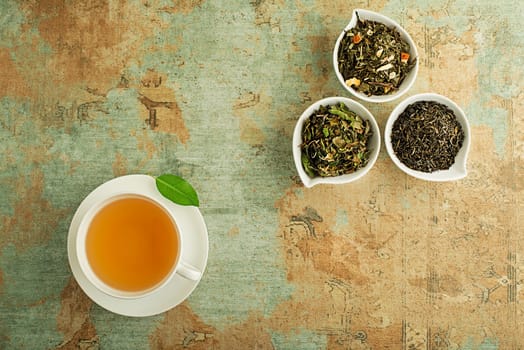 Cup of tea with dry tea collection of different types- classic black and green tea flavour