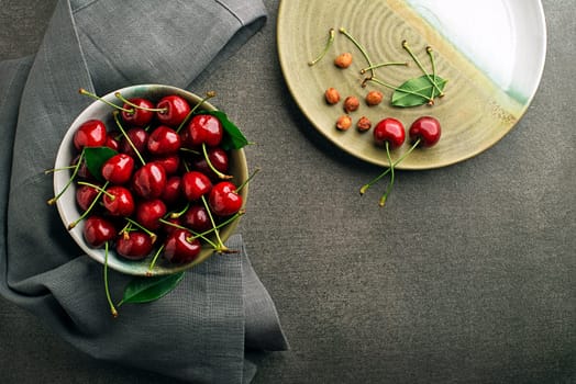 Bowl of fresh red cherries on the table close up