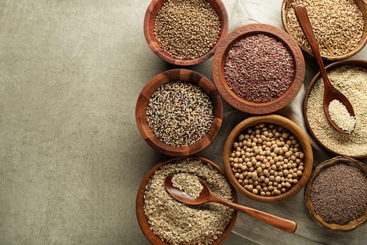 Various of healthy seeds and cereals - sesame, flax seed, chia seeds, soybean, buckwheat and oats. Copy space.